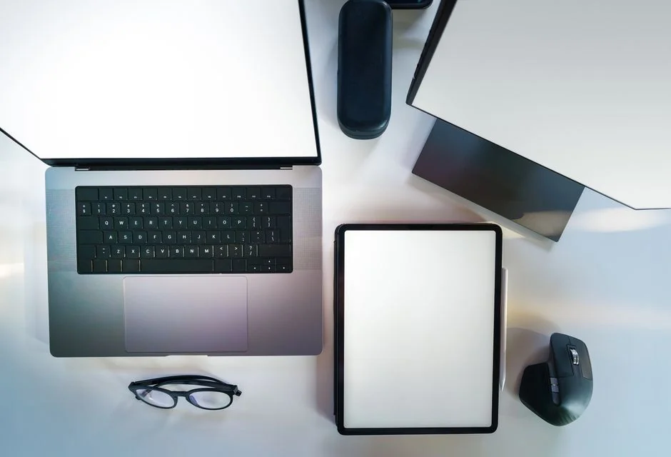 Overhead view of a corporate team collaborating with laptops and documents.